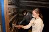 Patricia Dawson, senior history major, whitewashes the walls of a historic cabin at Parker's Crossroads Battlefield with Gracie Wise, junior English major, during Union's tenth annual Campus and Community Day. - Photo by Jacob Moore