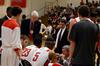 James Patterson, honorary coach and associate dean of the school of theology and missions, and Trevor Lydic, assistant coach, listen as David Niven, head coach, talks with the Bulldog basketball team during a time-out in a game against Central Baptist College.  - Photo by Anne Richoux