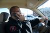 Adam Panisiak, shift supervisor for Safety and Security, takes a call on the office's cellphone while on patrol. - Photo by Jacob Moore
