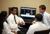 Ashok Philip, assistant professor of pharmaceutical sciences, talks with students in a pharmacy lab. - Photo by Kristi McMurry