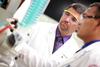 Blake Watkins, chair and associate professor of pharmaceutical sciences, works with a student on a lab experiment. - Photo by Kristi McMurry