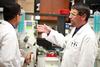 Blake Watkins, chair and associate professor of pharmaceutical sciences, works with a student on a lab experiment. - Photo by Kristi McMurry