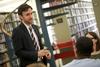 Jason Crawford, assistant professor of English, talks to a couple of students in the library.  - Photo by Kristi McMurry