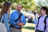 Scott Huelin, associate professor of English and director of the honors community, stops outside to chat with a couple of students. - Photo by Kristi McMurry