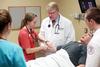Tim Smith, dean of the school of nursing, guides a group of students through a task in the simulation lab. - Photo by Kristi McMurry
