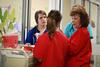 Mary Lee Jacobson, assistant professor of nursing, helps a group of nursing students prepare for a simulation. - Photo by Kristi McMurry