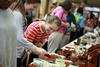 Students and community members shop the annual Christmas pottery sale. Most of the artwork displayed is made by students, with a few tables of faculty and staff work as well. - Photo by Kristi McMurry
