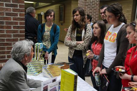 Author Ben Sáenz talks with a group of students during the book signing following his poetry reading. 