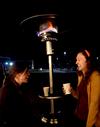 Anne Richoux, junior social work major, and Kristen Reed, junior nursing major, chat and enjoy hot chocolate near a heater at the Homecoming Winter Wonderland. - Photo by Olivia Wallace