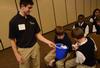 3/7/13 - Dalton DeLuca, sophomore business administration major, collects the evaluation forms from the students at the Toy Design Expo. - Matt McDaniel