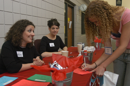 Juniors Ashley Mitchell and Jodie Curtis help incoming freshmen sign in during The Spring Thing Weekend.