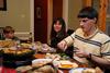 Georg Pingen, assistant engineering professor, and his family enjoy a home-cooked meal with students for SAC's Be Our Guest. - Photo by Anne Richoux