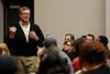 Norman Hill, chair of the university board of trustees, talks with students about what they can do during the presidential transition at a Student Senate meeting. - Photo by Anne Richoux