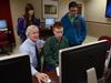 Jim Veneman, assistant professor of communication arts, guides students through a feature on Photoshop after digital photography class. - Photo by Jacob Moore
