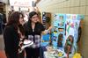 Sophomore Alma Hernandez talks about Guatemala with Esperanza Aguilar, secretary and student success advocate for the Vocatio Center, during the CultureFEST culture fair. - Photo by Jacob Moore