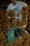 Juniors Holly Burnett and Lewis Curd work together in the wheelbarrow race during the Young Alum's Midnight Mudness. - Photo by Jonathan Blair