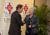 Nick Saban, head football coach at the University of Alabama, greets Deb Rhodes, office coordinator of university communications, at the fifth annual Roy L. White Legacy Golf and Gala. - Photo by Jacob Moore