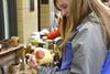 Anita Doll, senior accounting major, chooses a piece of pottery at the annual mother's day pottery sale, which is hosted by the Potter's Guild.  - Photo by Olivia Wallace