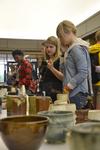 Students enjoy picking out pieces of pottery made by their peers at the annual Mother's Day pottery sale.  - Photo by Olivia Wallace
