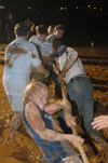 Juniors tug hard during the mud tug-of-war during the Young Alum's Midnight Mudness. - Photo by Jonathan Blair