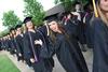 Lauren Ritchie, graduate of nursing, happily makes her way to the Great Lawn at the beginning of Spring Graduation. - Photo by Matt McDaniel