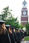 Graduates walk toward the Great Lawn during the processional at Spring Graduation.  - Photo by Anne Richoux