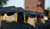 Graduates listen to David S. Dockery's welcome during Spring Graduation on the Great Lawn. - Photo by Jacob Moore