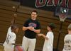 Trevor Lydic, assistant men's basketball coach, works with children participating in the athletic department's basketball Pee Wee Camp held in the Fred DeLay Gymnasium. - Photo by Jacob Moore