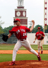 Bill Stewart (28) tosses some warmup pitches during the Alumni Game activities.  Josh Allen (11) laughs as he gets to try a new position at third during the game putting the current players versus the alumni. - Photo by Jonathan Blair