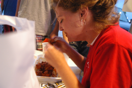 Lauren Oldham eats a very hot batch of hot wings at Buffalo Wild Wings during a challenge at the Watters Amazing Race.
