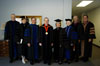 James Patterson, Carla Sanderson, Tom Rosebrough, David S. Dockery, Judy Fletcher, Donna Sachse, Kelvin Moore, and Keith Absher pose in their regalia shortly before summer graduation. - Photo by Morris Abernathy