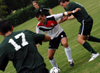 Senior Redzi Stojiljkovic attempts to keep the ball from three Belhaven (Miss.) players. - Photo by Jonathan Blair