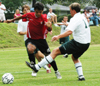 Diego Rojas (15)attempts to dribble through two Delta State defenders. - Photo by Jonathan Blair