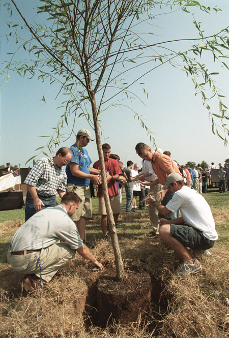 Students, faculty and staff remove the stones
surrounding the memorial tree.