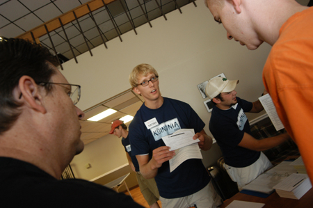 Residence assistants Nathan Michael and Chris Campbell help incoming freshmen with their dorm assignments during Freshmen Move-In.