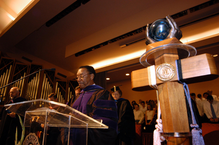 Roland Porter, new associate professor of business administration, prays during Fall Convocation 2004.