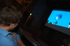 Junior digital media studies major Nic Pfost watches Tyson Cadenhead's <i>The Perfect Dorm Room</i> along with a roomful of film fans at the 2004 Student Film Festival. Nic won the Jury's Award for a short form film that night for <i>The Femail Box.</i> - Photo by Kristen Nicole Sayres