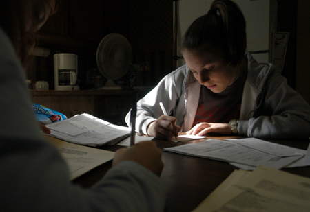 Senior Jenny Buffington does paper work at Area Relief Ministries during Day of Remembrance.