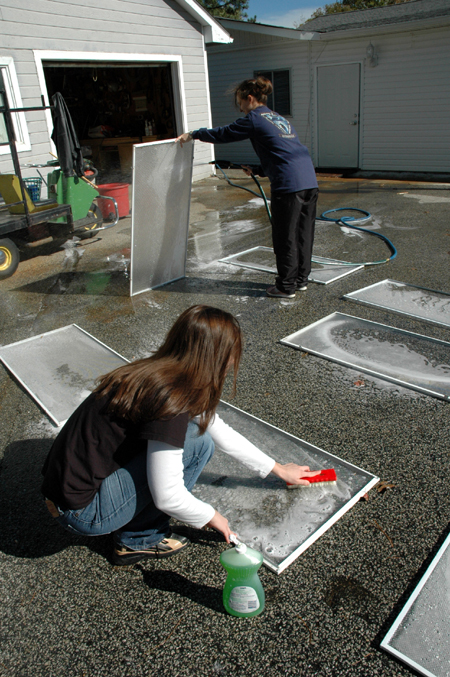 Bess Perrier and Stefi Brazzeal clean window screens at Birth Choice during Day of Remembrance.