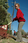 Junior Melody Pickerill rakes leaves at Birth Choice during Day of Remembrance. - Photo by Amanda Herron