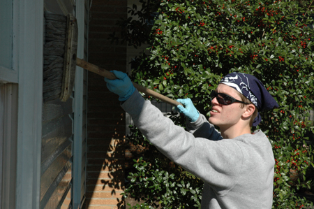 Senior Adam Winters washes shutters and windows at Birth Choice during Day of Remembrance.