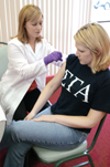Accelerated BSNA student Emily Gisi gives a flu vaccination to junior nursing major Charity Crisp. - Photo by Kristen Hiller