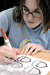 Sophomore, Heather Fleming recreates games lost during the tornado that hit Denmark Elementary. The second annual Day of Remembrance was a time to serve in Jackson. - Photo by Kathleen Murray