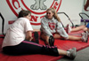 Senior Kari Barnhart and freshman Stefie Glass stretch before their intense workout during Ladies Night in the Wellness Center. - Photo by Amanda Herron