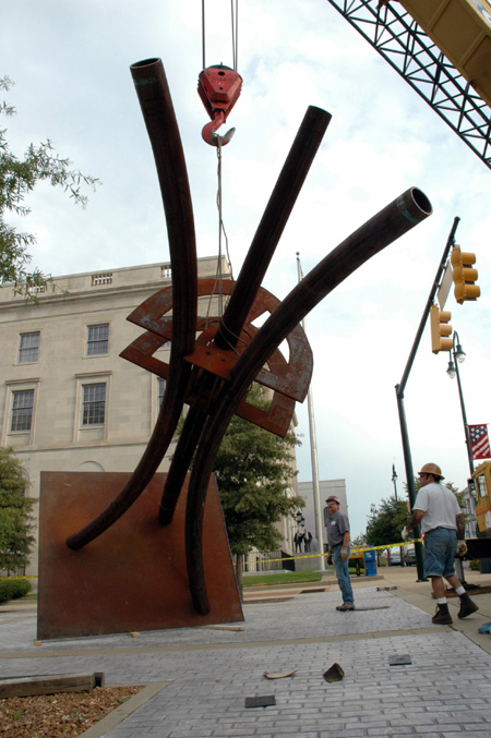 Contemporary artist STRETCH, right, oversees the installation of his sculpture, "Guardian."  This piece is one of the selections for the Jackson Union Sculpture Tour (JUST).