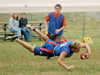 Sophomore Brett Jenkins, Christian studies major, tries to soften his fall as he stretches for extra yards as senior Micah Moyers, DMS major, looks on during an intramural football game. - Photo by Kristen Hiller