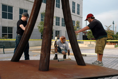 Contemporary artist STRETCH, center, oversees the installation of his sculpture, "Guardian." This piece is one of the selections for the Jackson Union Sculpture Tour (JUST).