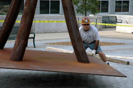 Contemporary artist STRETCH oversees the installation of his sculpture, "Guardian." This piece is one of the selections for the Jackson Union Sculpture Tour (JUST).
