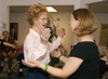 Jackson Meadow resident and dance instructor Mary McCroskey welcomed a hug from junior Kathleen Lokey, social work major and joint-chair of the SAC event, after the two shared a dance at SAC's "Night Under the Stars," Nov. 16. - Photo by Kristen Hiller