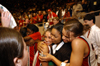 Senior's Laura Mitchell (left) and Stephanie Clark (right) give graduate assistant Tonya Tuggles a sandwich hug after Union's win in the title game of the NAIA National Tournament. - Photo by Morris Abernathy